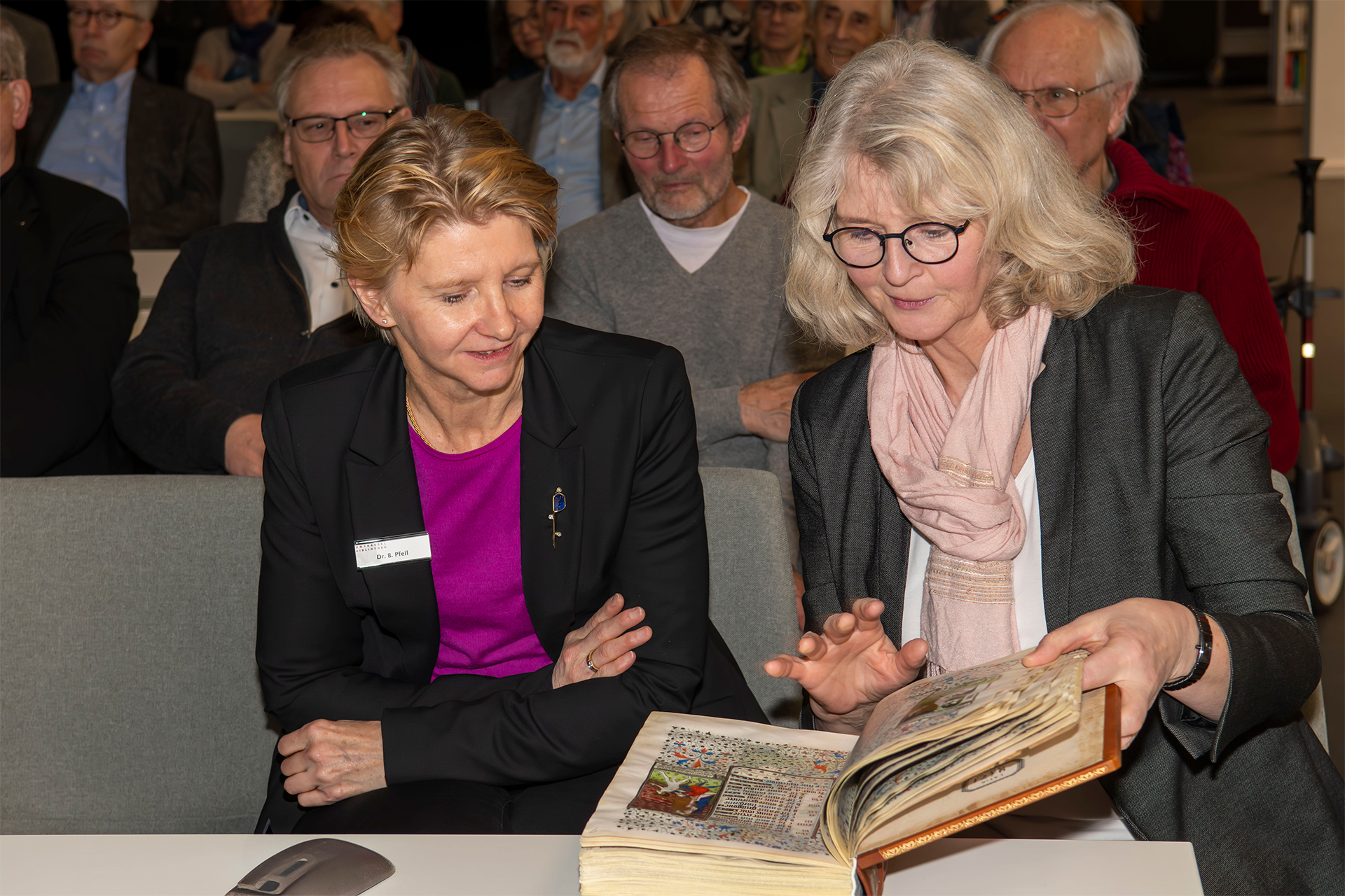 Head of the Manuscript and Special Collections Dr. Brigitte Pfeil-Amann (left) and Head Librarian Claudia Martin-Konle leaf through the facsimile of the Rohan Hours brought along by the brothers Ziereis Head of the Manuscript and Special Collections Dr. Brigitte Pfeil-Amann (left) and Head Librarian Claudia Martin-Konle leaf through the facsimile of the Rohan Hours brought along by the brothers Ziereis
