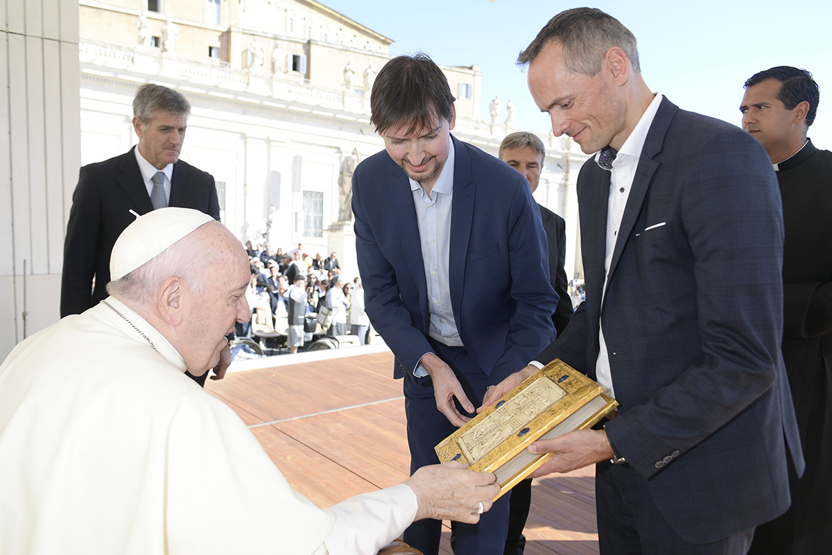 Pope Francis admires the magnificent cover of the facsimile edition, which is embellished with 24-carat gold leaf. Photo (c) Vatican Media